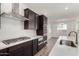 Modern kitchen with stainless steel appliances and dark cabinetry at 25233 N 131St Dr, Peoria, AZ 85383