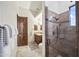 Modern bathroom with a large glass shower and wood vanity at 25763 N 116Th St, Scottsdale, AZ 85255