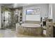 Spa-like bathroom with a soaking tub and walk-in shower at 25763 N 116Th St, Scottsdale, AZ 85255