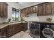 Laundry room with washer, dryer, and ample counter space at 25763 N 116Th St, Scottsdale, AZ 85255