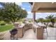 Outdoor kitchen with grill and granite countertops at 25763 N 116Th St, Scottsdale, AZ 85255