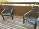 Private balcony with two metal chairs and wood decking at 2625 E Indian School Rd # 226, Phoenix, AZ 85016