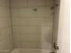 Clean bathroom with a shower/tub combo and tile surround at 2625 E Indian School Rd # 226, Phoenix, AZ 85016