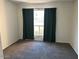 Well-lit bedroom with dark green curtains and carpet at 2625 E Indian School Rd # 226, Phoenix, AZ 85016