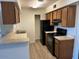 Modern kitchen with black appliances and wood cabinets at 2625 E Indian School Rd # 226, Phoenix, AZ 85016