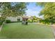 Spacious backyard with lush green grass and a patio table set at 3111 E Red Oak Ct, Gilbert, AZ 85297