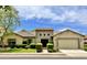 Single-story home with tile roof, stone accents, and a two-car garage at 3111 E Red Oak Ct, Gilbert, AZ 85297