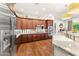 Spacious kitchen featuring wood cabinetry, granite countertops, and stainless steel appliances at 3111 E Red Oak Ct, Gilbert, AZ 85297