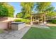 Outdoor kitchen and dining area with pergola, ideal for entertaining at 3111 E Red Oak Ct, Gilbert, AZ 85297