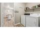 Laundry room with modern appliances, shelving, and an open view to the dining room at 335 S Stardust Ln, Apache Junction, AZ 85120