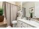 Bathroom with granite countertop, white cabinets, and shower/tub combo at 3412 E Indigo Cir, Mesa, AZ 85213