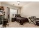 Cozy bedroom featuring a comfortable bed, ceiling fan, and natural light from the window at 3412 E Indigo Cir, Mesa, AZ 85213