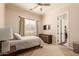 Cozy bedroom with window, dresser, and ceiling fan at 3412 E Indigo Cir, Mesa, AZ 85213