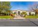 House exterior with stone accents, landscaping, and a large front yard at 3412 E Indigo Cir, Mesa, AZ 85213