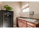 Convenient laundry room with sink, counter space, and ample cabinet storage at 3412 E Indigo Cir, Mesa, AZ 85213