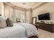 Main bedroom featuring a large bed, plenty of light, and a flat-screen TV at 3412 E Indigo Cir, Mesa, AZ 85213