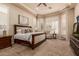 Main bedroom with carpeted floors and a cozy seating area at 3412 E Indigo Cir, Mesa, AZ 85213