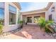 Covered patio with terracotta tile flooring and lush landscaping at 3412 E Indigo Cir, Mesa, AZ 85213