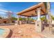 Covered patio with outdoor kitchen and ceiling fan at 3412 E Indigo Cir, Mesa, AZ 85213