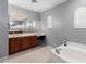 Large bathroom with double vanity, soaking tub and walk-in shower at 3959 E Gemini Pl, Chandler, AZ 85249