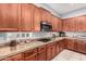 Kitchen with granite countertops and wood cabinets at 3959 E Gemini Pl, Chandler, AZ 85249