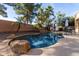 Relaxing pool with patio furniture, landscaping, and large rocks at 3959 E Gemini Pl, Chandler, AZ 85249