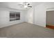 Bedroom with bathroom access and ceiling fan at 4225 N 92Nd Ln, Phoenix, AZ 85037