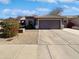 Single-story house with attached garage and desert landscaping at 4225 N 92Nd Ln, Phoenix, AZ 85037