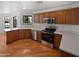 Modern kitchen with stainless steel appliances and wood cabinets at 4225 N 92Nd Ln, Phoenix, AZ 85037