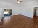 Spacious living room with hardwood floors and access to backyard at 4225 N 92Nd Ln, Phoenix, AZ 85037