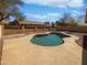 Inviting kidney-shaped pool with a large patio area at 4225 N 92Nd Ln, Phoenix, AZ 85037