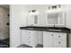 Modern bathroom with double vanity and dark countertops at 4242 E Sacaton St, Phoenix, AZ 85044