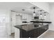 Updated kitchen featuring white shaker cabinets and a breakfast bar at 4242 E Sacaton St, Phoenix, AZ 85044