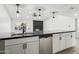 Modern kitchen with white cabinets, black countertops, and stainless steel appliances at 4242 E Sacaton St, Phoenix, AZ 85044