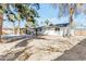 Rear exterior highlighting the covered patio, refreshing pool, and mature landscaping at 4311 E Bluefield Ave, Phoenix, AZ 85032