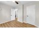 Bright bedroom featuring wood-look floors, neutral walls, ceiling fan, and bright-white doors at 4311 E Bluefield Ave, Phoenix, AZ 85032