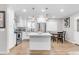 Bright kitchen with stainless steel appliances, white cabinets, an island with seating, and a subway tile backsplash at 4311 E Bluefield Ave, Phoenix, AZ 85032