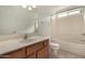 Clean bathroom with a tub, vanity, and tiled floor at 432 E Harrison St, Chandler, AZ 85225