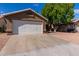 Attached garage with a white door and gravel driveway at 432 E Harrison St, Chandler, AZ 85225