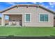 Home exterior with covered patio and grassy yard at 463 W Pinnacle Ridge Dr, San Tan Valley, AZ 85140