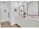 Double vanity bathroom with white cabinets and gray mirrors at 463 W Pinnacle Ridge Dr, San Tan Valley, AZ 85140