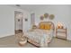 Bright bedroom with a wicker bed frame and ensuite bathroom access at 463 W Pinnacle Ridge Dr, San Tan Valley, AZ 85140