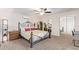 Spacious bedroom with large bed, mirrored closet doors and ceiling fan at 466 E 10Th Pl, Mesa, AZ 85203