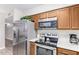 Kitchen features stainless steel appliances and wood cabinets at 466 E 10Th Pl, Mesa, AZ 85203