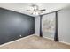 Spacious bedroom with gray accent wall, window, and ceiling fan at 4678 E Jadeite Dr, San Tan Valley, AZ 85143