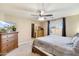 Main bedroom with dresser, TV, and access to the bathroom at 4678 E Jadeite Dr, San Tan Valley, AZ 85143