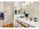 Clean bathroom with a marble-walled shower, white cabinetry, and wood-style floors at 46827 N 8Th Ave, New River, AZ 85087