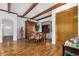 Dining room features a wood table, six chairs, hardwood flooring, and natural light from a large window at 46827 N 8Th Ave, New River, AZ 85087