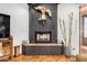 Close-up of the living room's black stone fireplace and hearth, adorned with an artistic totem and logs at 46827 N 8Th Ave, New River, AZ 85087