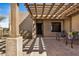 Covered front entry porch with a tiled walkway and decorative seating at 46827 N 8Th Ave, New River, AZ 85087